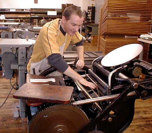 Volunteering: Paul Moxon adjusting the 8 x 12 Peerless treadle press.